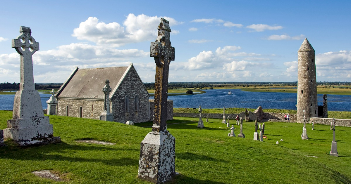 Celtic crosses, a church, and a tower standing in Clonmacnoise. A major historical and cultural attraction in the Midlands of Ireland.